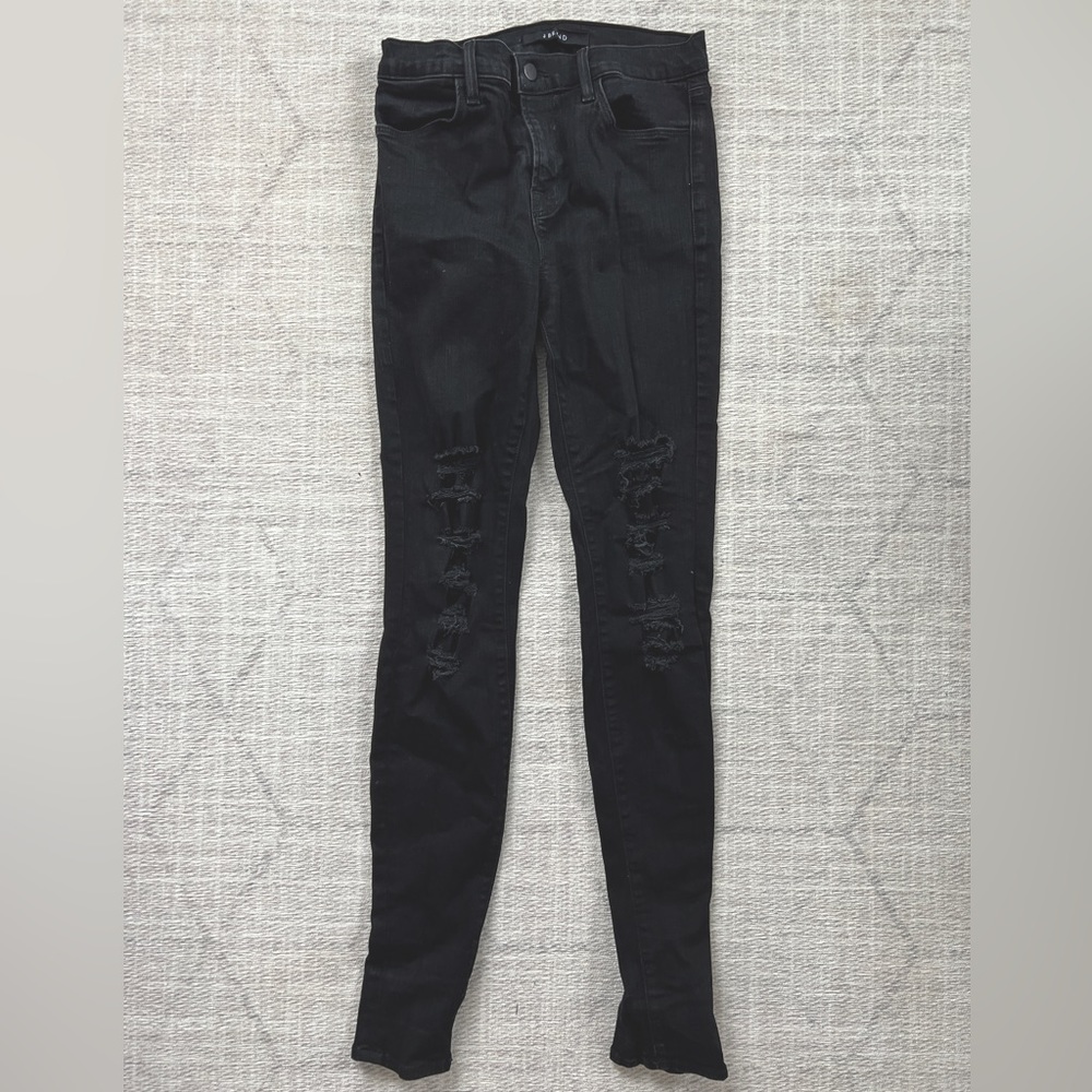 J Brand black high rise, skinny jeans. Distressed with holes up both legs.